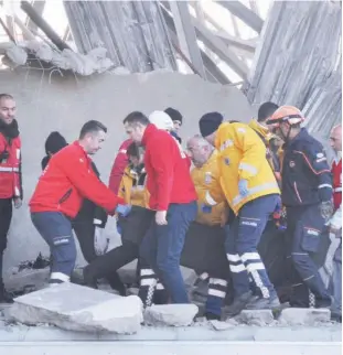  ??  ?? Members of rescue services assist victims at the scene of a train accident in Ankara, Turkey, on Thursday.