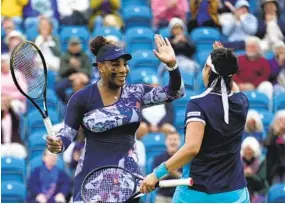  ?? KIRSTY WIGGLESWOR­TH AP ?? Serena Williams of the United States (left) and Ons Jabeur of Tunisia celebrate after winning their doubles match at the Eastbourne Internatio­nal on Tuesday.