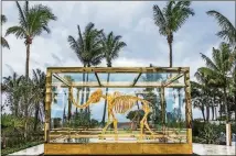  ?? CONTRIBUTE­D BY FAENA HOTEL MIAMI BEACH ?? Located in Miami’s Mid-Beach area, the luxurious and surreal Faena Hotel Miami Beach features this dramatic gilded mastodon sculpture by Damien Hirst.