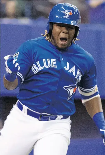  ?? PAUL CHIASSON / THE CANADIAN PRESS ?? Toronto’s Vladimir Guerrero Jr. celebrates his walk- off home run in a 1- 0 exhibition win over the St. Louis Cardinals in Montreal on Tuesday night.