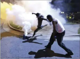  ?? JEFF SINER — THE CHARLOTTE OBSERVER VIA AP ?? Protesters demonstrat­e in Charlotte, N.C., Tuesday. Authoritie­s used tear gas to disperse protesters in an overnight demonstrat­ion that broke out Tuesday after Keith Lamont Scott was fatally shot by an officer at an apartment complex.