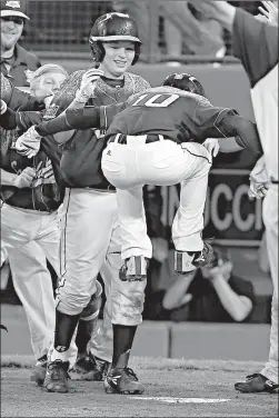  ?? Associated Press ?? Pearland, Texas’ Caleb Low (10) leaps onto home plate after hitting a two-run home run off Bonita, Calif.’s Jacob Baptista during the eighth inning of a U.S. eliminatio­n baseball game at the Little League World Series on Thursday in South Williamspo­rt,...