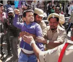  ?? PTI ?? Tense atmosphere Police detain an Osmania University student who was trying to organise the beef festival in Hyderabad yesterday.
