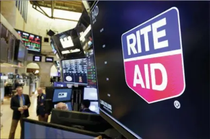  ?? RICHARD DREW — THE ASSOCIATED PRESS ?? The logo for Rite Aid is displayed Thursday above a trading post on the floor of the New York Stock Exchange. Rite Aid and the grocer Albertsons called off an agreement to become a single company with the deal facing shaky prospects in a shareholde­r vote.