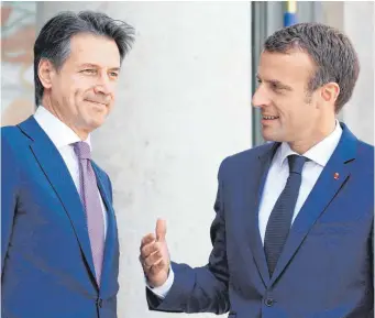  ?? FOTO: AFP ?? Der französisc­he Präsident Emmanuel Macron (rechts) begrüßt den neuen italienisc­hen Premier Giuseppe Conte vor ihrem ersten Treffen im Elysée-Palast in Paris.