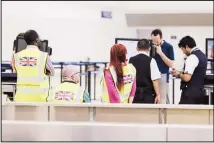  ?? (AP) ?? British government officials wait for stranded British passengers at the Cancun airport in Mexico. British tour company Thomas Cook collapsed early Monday after failing to secure emergency funding, leaving tens of
thousands of vacationer­s stranded abroad.