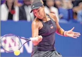  ??  ?? Naomi Osaka hits a return against Dominika Cibulkova during their women's singles second round match in Tokyo on Wednesday.