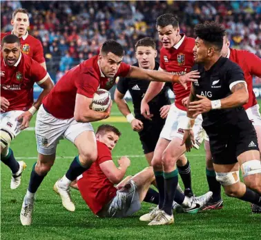  ??  ?? Move it!: British and Irish Lions’ Conor Murray (third from left) goes for a try against New Zealand’s All Blacks during the second rugby union Test in Wellington yesterday. Right: New Zealand All Blacks’ Sonny Bill Williams (right) is shown the red...