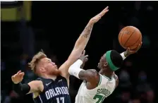  ?? MATT STONE / HERALD STAFF ?? ’LET IT FLY’: Celtics guard Dennis Schroder shoots over Orlando’s Ignas Brazdeikis on Monday night.