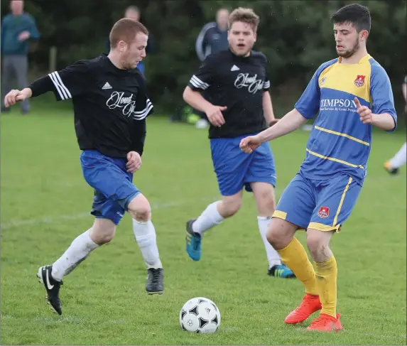  ??  ?? Curtis Meade of Thatch and Sam Donegan (Grove Rangers) battle for supremacy during Sunday’s NEFL Division 4 game in Monasterbo­ice.