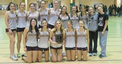  ?? ?? Members of the Hereford girls indoor track and field team pose with their plaque after winning another Baltimore County title Tuesday.
