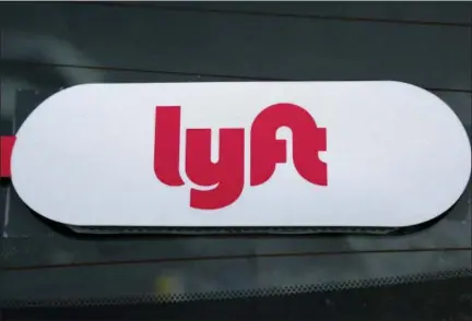  ?? GENE J. PUSKAR — THE ASSOCIATED PRESS FILE ?? This Lyft logo IS on a Lyft driver’s car in Pittsburgh. Lyft officially kicked off the road show for its initial public offering Monday with 30 million shares expected to cost between $62 and $68 per share.