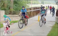  ?? Keith Bryant/The Weekly Vista ?? The bike parade ended shortly after this newly constructe­d bridge near the Veterans Wall of Honor. Many riders kept going along the greenway and into the Bentonvill­e square.