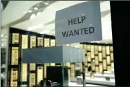  ?? (AP/Lynne Sladky) ?? A help wanted sign is posted at a Designer Eyes store at Brickell City Centre in Miami last month. About 885,000 people applied for unemployme­nt aid last week.
