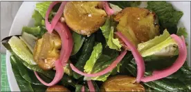  ?? CATHY THOMAS - COUTESY PHOTO ?? This green salad with spinach, romaine and basil is topped with freshly baked smashed potatoes.