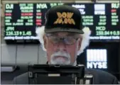  ?? THE ASSOCIATED PRESS ?? Frader Peter Tuchman wears a “Dow 26,000” hat as he works on the floor of the New York Stock Exchange Aug. 27.
