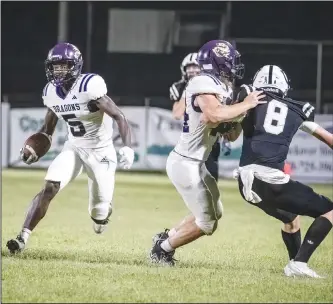  ?? Southern Sass/Special to the News-Times ?? Gaining yards: Junction City’s Dovonte’ Grimes (5) picks up yards during the Dragons’ 5-3A showdown against Smackover earlier this season. The Dragons capped the regular season with a 55-6 win at Gurdon on Thursday with Grimes hauling in two touchdown passes in the win. Junction City will host a first-round playoff game next week as the conference’s No. 2 seed.