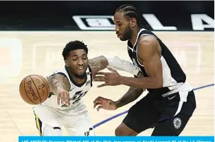  ??  ?? LOS ANGELES: Donovan Mitchell #45 of the Utah Jazz passes as Kawhi Leonard #2 of the LA Clippers defends during the second half of a game at Staples Center on Saturday. —AFP