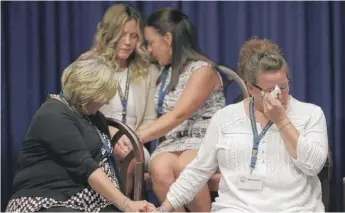  ?? MATT ROURKE/AP ?? People react Aug. 14 as Pennsylvan­ia’s attorney general reads details of the grand jury investigat­ion into the state’s clergy abuse. The report detailed the sexual assault of hundreds of children.