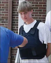  ?? Asssociate­d Press ?? n Dylann Storm Roof is escorted from the Shelby Police Department on June 18 in Shelby, N.C.