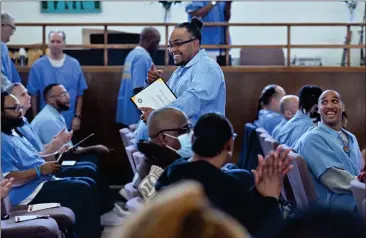  ?? PHOTOS BY SHERRY LAVARS — MARIN INDEPENDEN­T JOURNAL ?? San Quentin inmate Harold Meeks points to a supporter in the audience after receiving a certificat­e of completion in coding at the prison. He was among 58inmates who received certificat­ions.