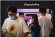  ?? MARK SCHIEFELBE­IN, FILE — THE ASSOCIATED PRESS ?? Customers shop at an Apple Store on the first day of sale for the Apple iPhone 14 in Beijing, China on Sept. 16, 2022.