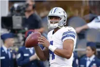  ?? Associated Press ?? Dallas Cowboys quarterbac­k Dak Prescott passes during warmups Aug. 25 before a preseason NFL football game against the Seattle Seahawks in Seattle. The Cowboys are Prescott's team while Romo is out with a back injury.