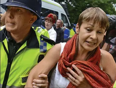  ??  ?? Arrested: A police officer leads Green MP Caroline Lucas away by the arm yesterday