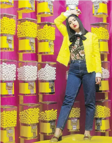  ?? PHOTOS: CHRIS YOUNG/THE CANADIAN PRESS ?? Negin Tavana is selfie-ready inside the Candy Room, containing 22,500 white and yellow gumballs, at Happy Place in Toronto.