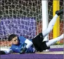  ?? WATCHARA PHOMICINDA — STAFF PHOTOGRAPH­ER ?? Etiwanda’s goalkeeper, Max Guerrero, dives to block a shot by Jurupa Hills in their CIFSS Division 4boys soccer quarterfin­al.