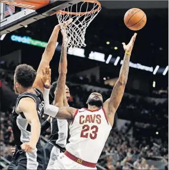  ?? [ERIC GAY/THE ASSOCIATED PRESS] ?? Cleveland’s LeBron James attempts to shoot over San Antonio’s Kyle Anderson, left, during Tuesday’s game.