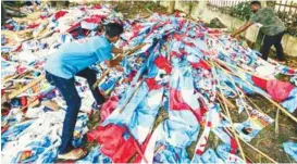  ??  ?? PKR members taking down the posters and flags after the election results yesterday.