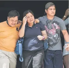  ??  ?? Relatives of a victim cry outside the Resorts World Hotel in Manila.