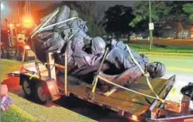  ?? AP ?? A monument dedicated to the Confederat­e Women of Maryland being taken away in Baltimore.