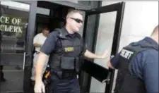  ?? TRENTONIAN FILE PHOTO ?? Mercer County sheriff’s deputies leave the City Clerks office Trenton City Hall Wednesday afternoon. Several city and county police vehicles and a series of officers came and went from the office in the hour before Cordelia Station’s departure.