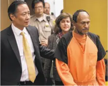  ?? Michael Macor / The Chronicle 2015 ?? San Francisco Public Defender Jeff Adachi (left) leads the defendant in Kate Steinle’s killing, now known as Jose Ines Garcia Zarate, into the Hall of Justice for arraignmen­t in 2015.