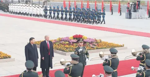  ??  ?? Xi (front left) and Trump attend a welcome ceremony at the Great Hall of the People in Beijing. — AFP photo