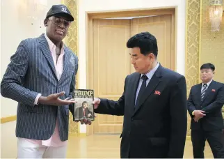  ??  ?? Dennis Rodman presents a copy of Donald Trump’s book The Art of the Deal to North Korean Sports Minister Kim Il Guk on June 15. Rodman’s post-NBA career included two turns on Trump’s show The Celebrity Apprentice.