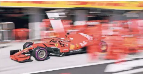  ?? FOTO: DPA ?? Sebastian Vettel fährt aus der Boxengasse. Der zu langsame Stopp ist am Ende ein Grund dafür, dass der Ex-Weltmeiste­r in Ungarn nicht ganz oben auf dem Treppchen landet.