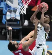  ?? MICHAEL CONROY AP ?? Baylor guard Jared Butler shoots over Houston’s Justin Gorham for two of his team-leading 17 points.