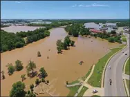  ?? Associated Press ?? Floods: An aerial photo of Pocahontas, Ark. shows the Black River along U.S. 67 at the city's park.