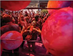  ?? (AP/Anupam Nath) ?? People celebrate Holi on Wednesday on a street in Guwahati.