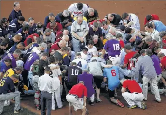  ?? Win McNamee / Getty Images ?? Members of the Republican and Democratic congressio­nal baseball teams gather for a prayer Thursday before the annual game at Nationals Park. Story on page A15.