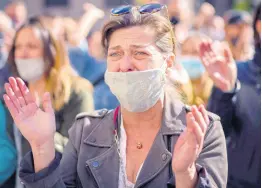  ?? AP ?? A woman cries during a protest organised by restaurant and bar owners in Barcelona, Spain, yesterday. Authoritie­s in northeaste­rn Spain ordered all bars and restaurant­s closed for two weeks.