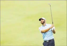  ?? Elsa / Getty Images ?? Dustin Johnson of the United States plays a shot on the 18th hole during the final round of the Travelers Championsh­ip at TPC River Highlands on Sunday in Cromwell.