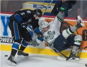  ?? CP PHOTO ?? Saint John Sea Dogs defenceman Thomas Chabot battles with Seattle Thunderbir­ds centre Matthew Wedman along the boards during a game at the Memorial Cup in Windsor, Ont. on Tuesday.