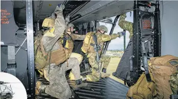  ?? Photos / NZDF ?? No 3 Squadron qualifies 2nd 1st RNZIR soldiers, at fast roping on Burnham Military Camp. INSET: Soldiers leave the NH90.