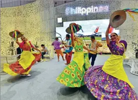  ?? YU XIANGJUN / FOR CHINA DAILY ?? Performers dance at the Philippine­s’ national pavilion at the CIIE in Shanghai on Wednesday.