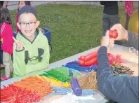  ?? CHRISTIAN ROACH/CAPE BRETON POST ?? Kallum MacDougall waits for a volunteer to make him a balloon helicopter at the Louisbourg Street Dance on Saturday.