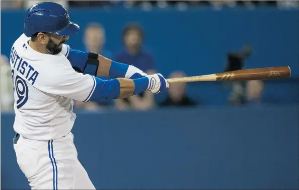  ?? — THE CANADIAN PRESS ?? The Blue Jays’ Jose Bautista hits a two-run homer off the Baltimore Orioles’ Jason Garcia in seventh inning of Toronto’s 13-6 home win on Tuesday. Bautista was clearly upset with Garcia after a close pitch, staring the pitcher down as the ball cleared...